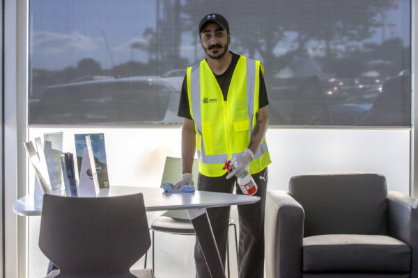 Professional commercial cleaner performing office sanitization and surface cleaning in Auckland