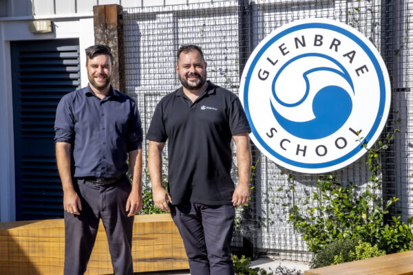Kōwhai Cleaning representative with a Glenbrae School staff member, highlighting a trusted school cleaning partnership in Auckland.