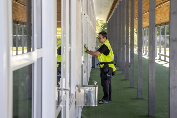 Kowhai Cleaning team member providing professional window cleaning at Glenbrae School facility