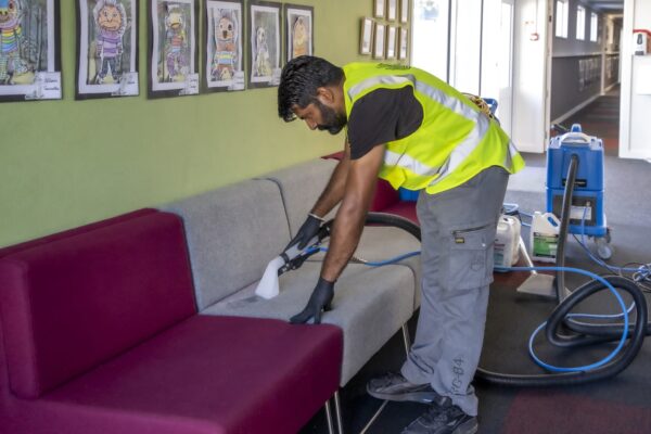 Professional upholstery cleaning at educational facility by Kowhai Cleaning using advanced equipment